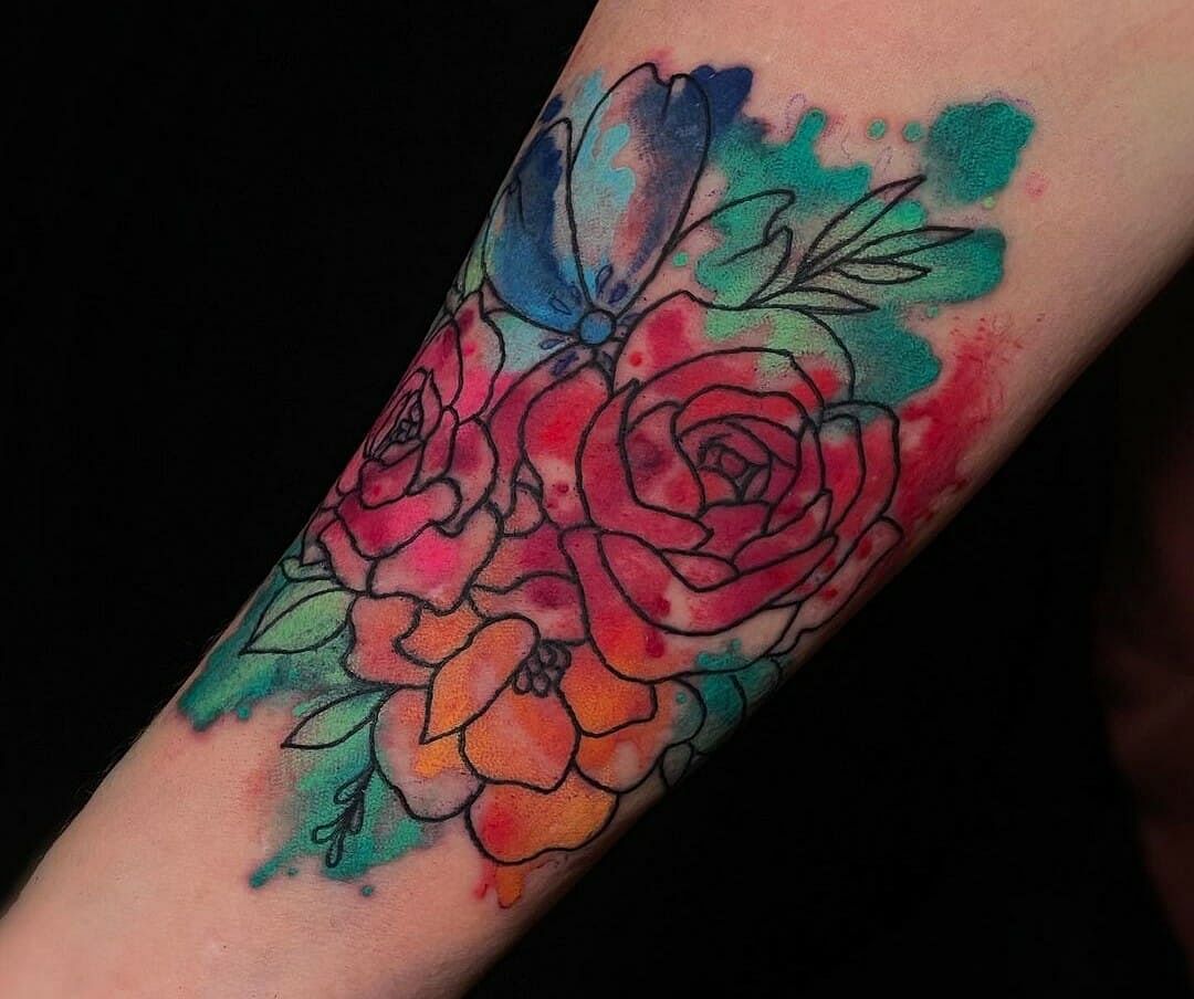 A versatile watercolor tattoo featuring an intricate landscape design